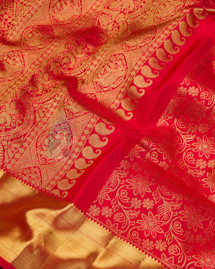 Close-up of red Kanjivaram silk saree showing floral zari design and gold border details
