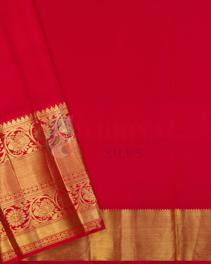 Plain red blouse piece of Kanjivaram silk saree with gold zari border