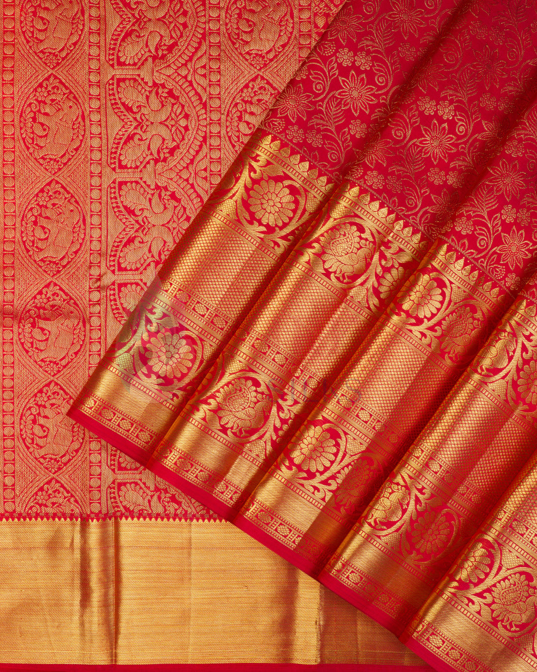 Red Kanjivaram silk saree with intricate golden zari pallu and traditional motifs
