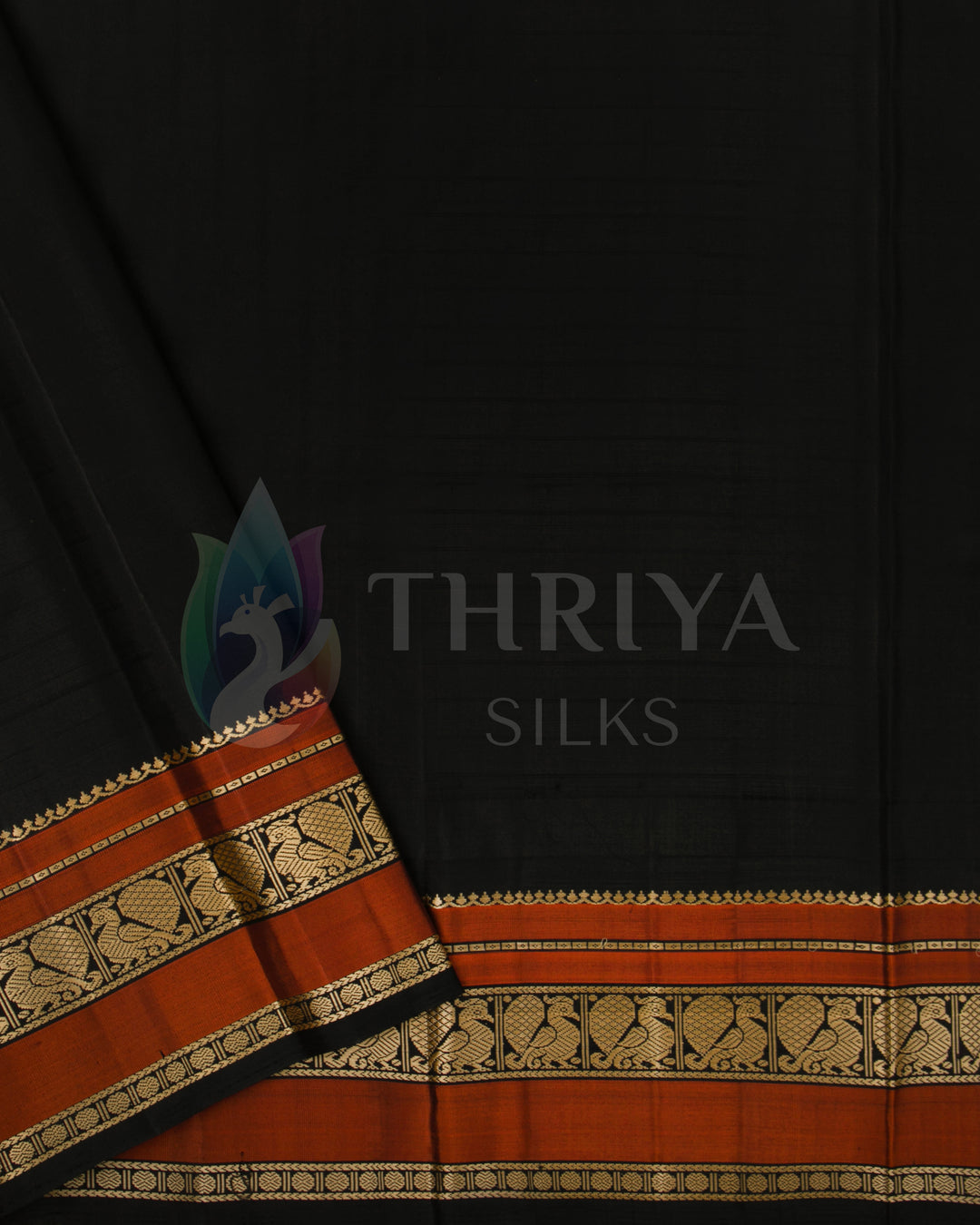 Contrasting black blouse piece with rust-orange and gold zari border, paired with beige saree from Thriya Silks