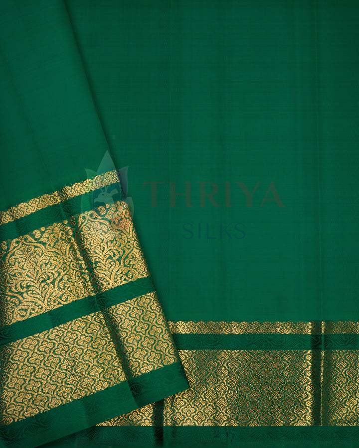 Dark green Kanchipuram silk saree with rich gold zari woven border
