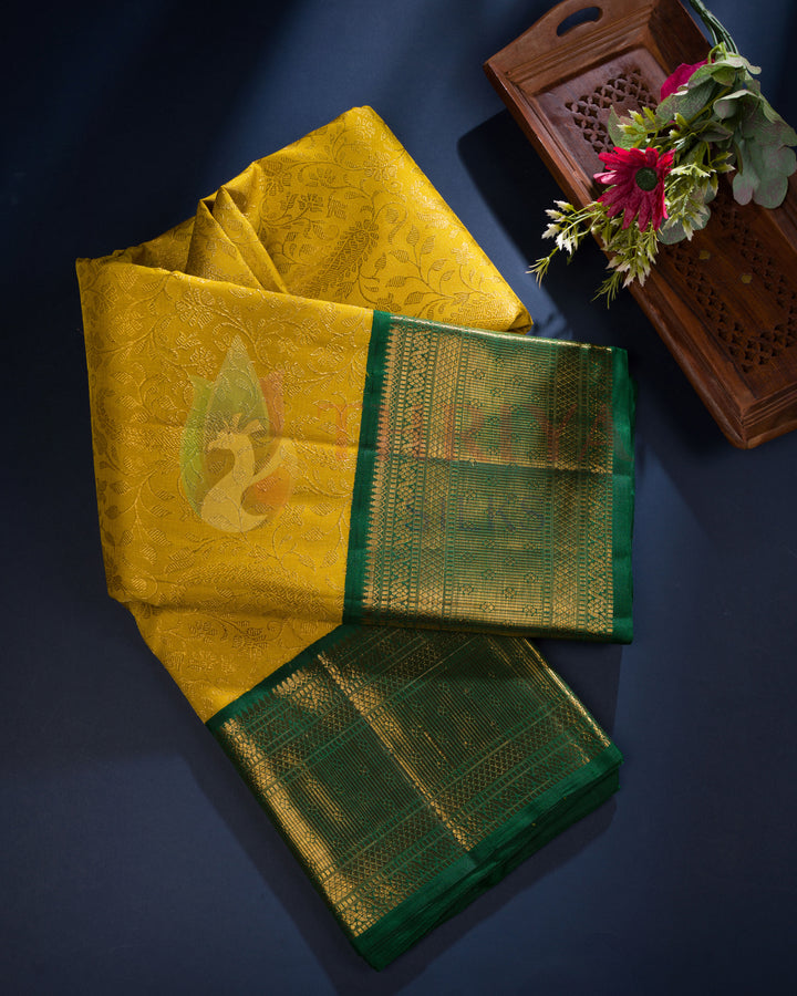 Draped mustard yellow and green Kanjivaram silk saree with gold zari – festive collection from Thriya Silks