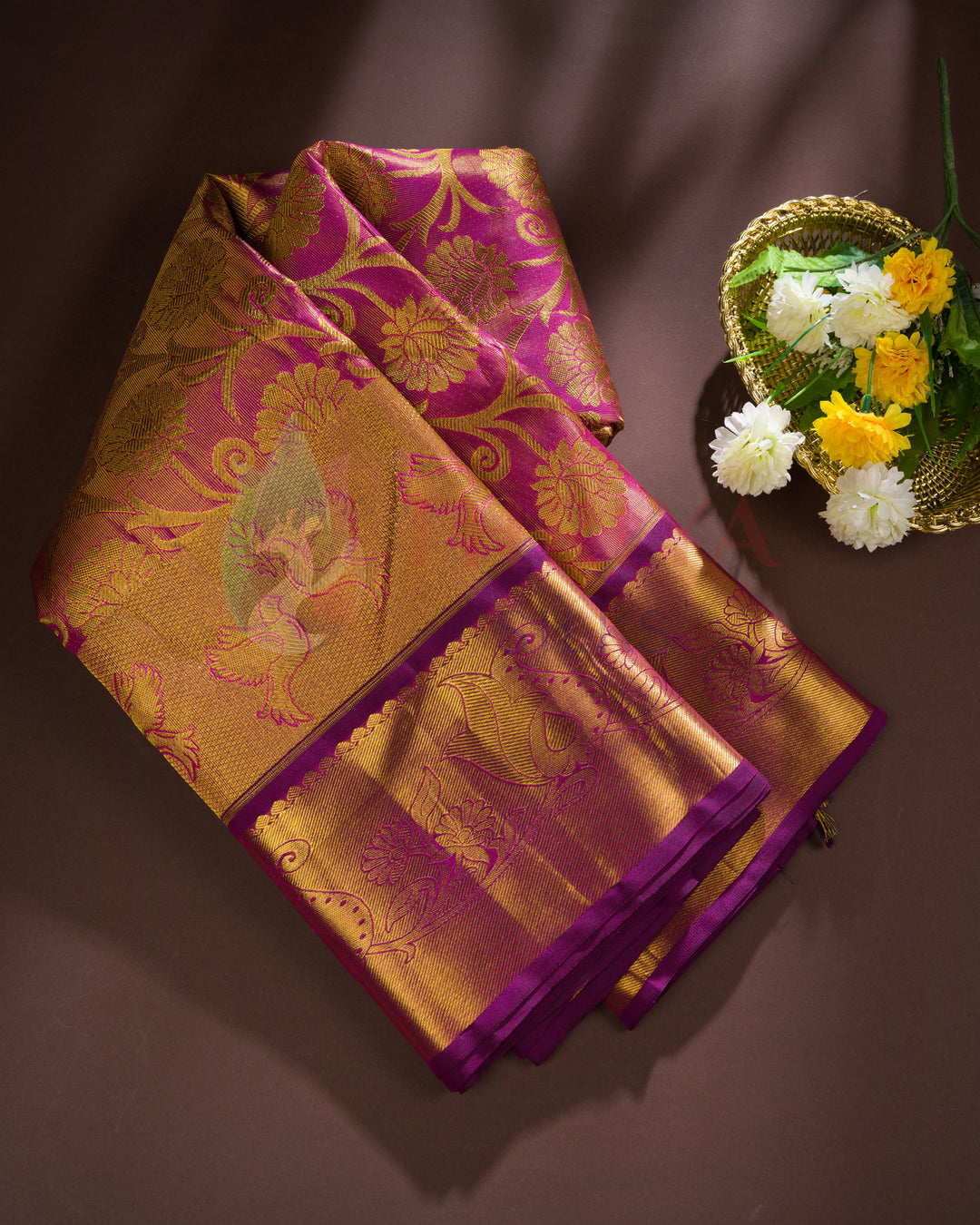 Folded magenta Kanjivaram silk saree with heavy gold zari pallu – festive and gifting silk saree