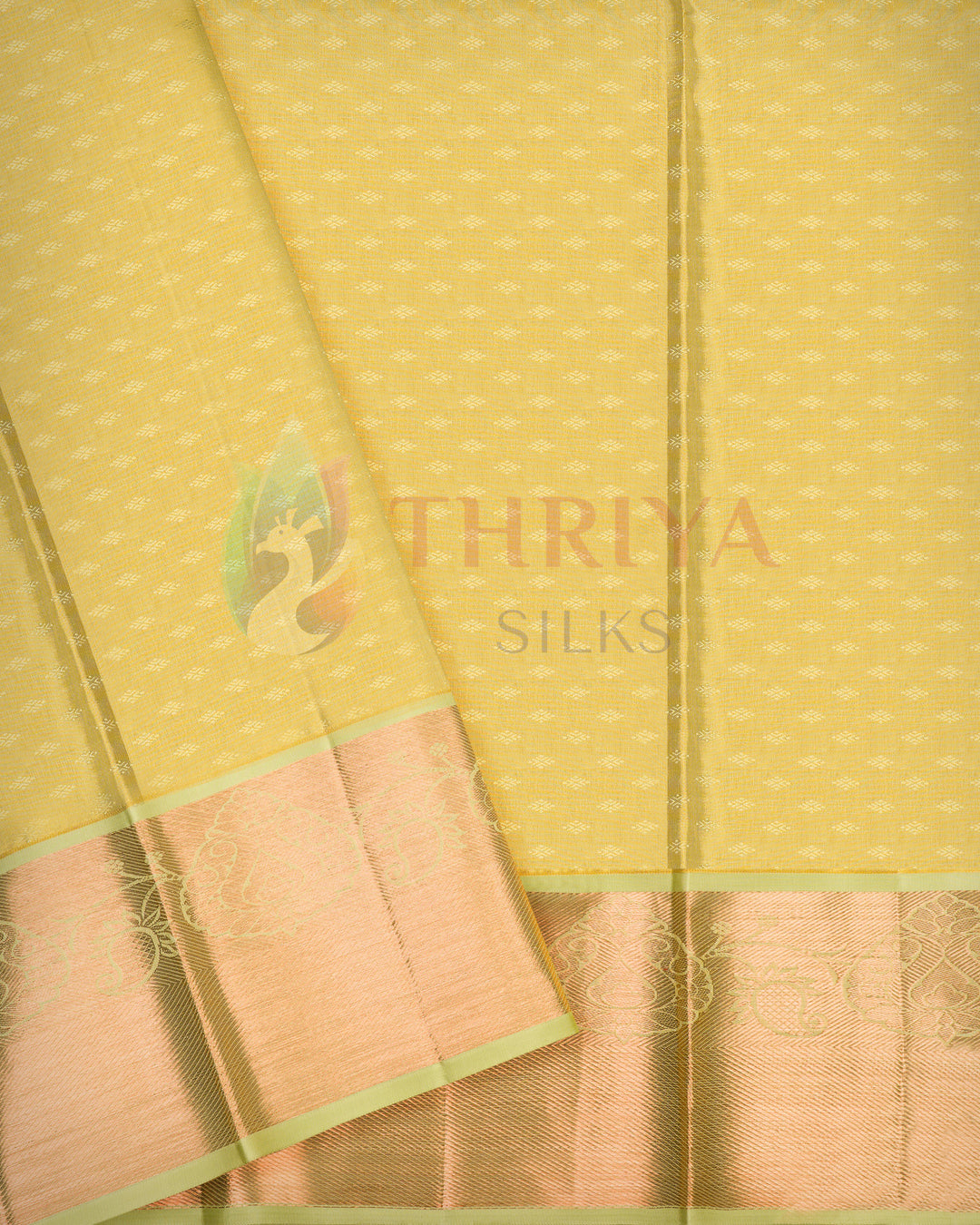 Full-length golden yellow Kanjivaram silk saree with green border spread out to reveal intricate design and rich silk texture.
