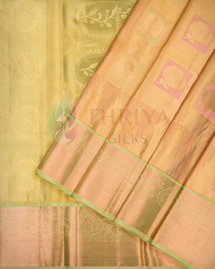 Traditional golden yellow Kanjivaram silk saree with green zari pallu displayed, showing exquisite craftsmanship.