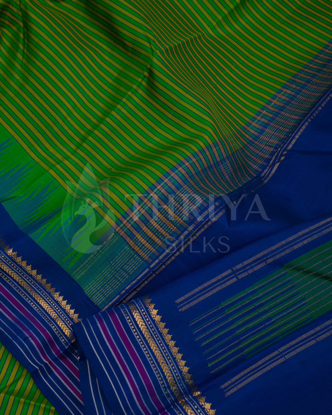 Close-up of green and blue silk saree fabric and detailed golden border work, Thriya Silks