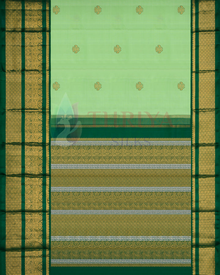 Light green Kanchipuram silk saree with gold floral buttas and intricately woven zari pallu