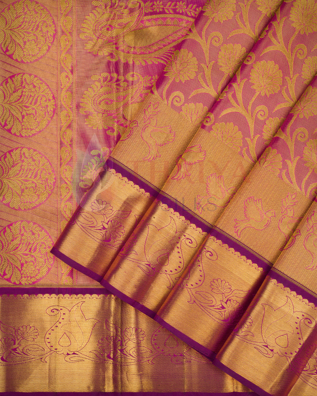 Magenta pink Kanjivaram silk saree with rich gold floral zari pleats and traditional border