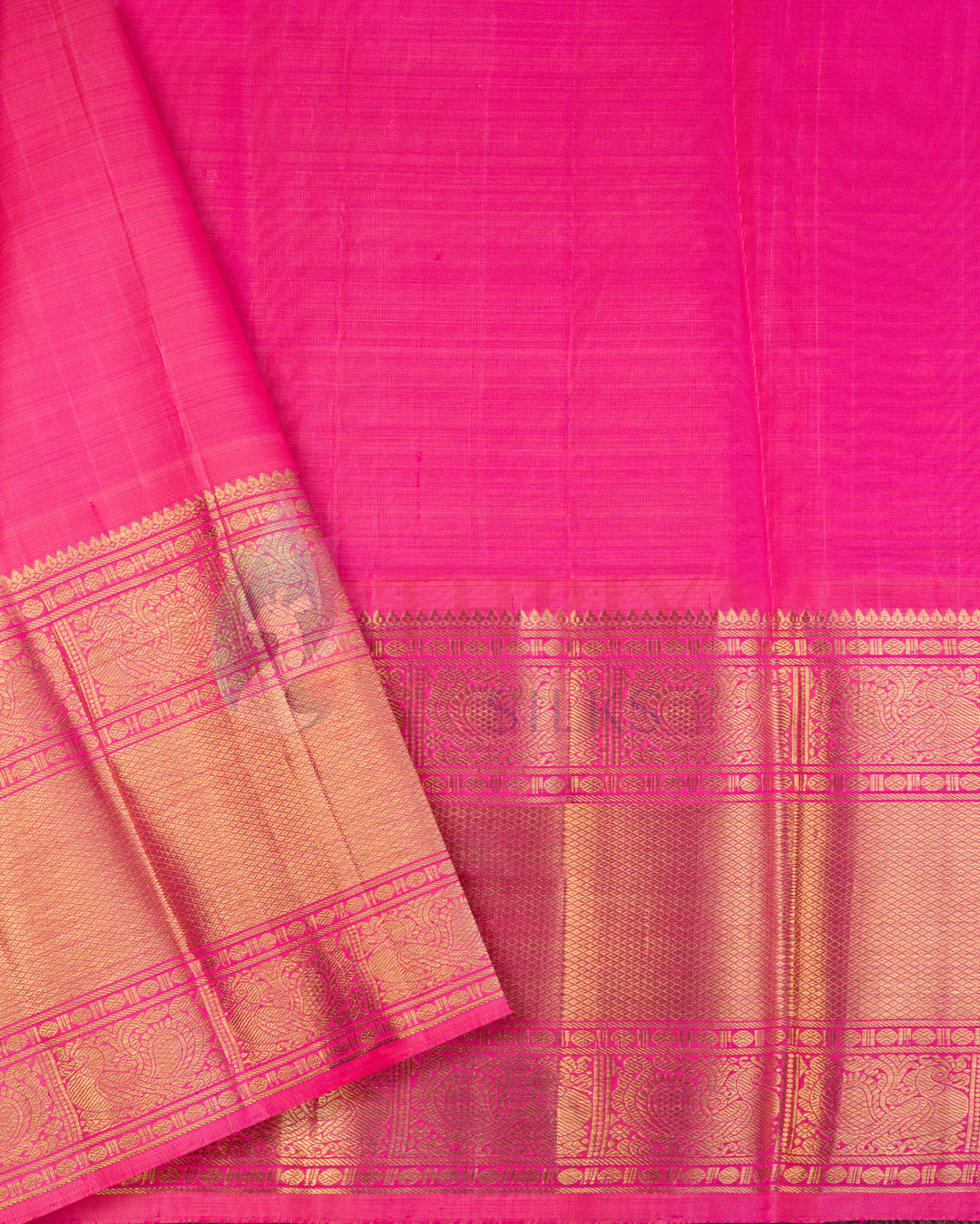 Pink pleats of Kanchipuram silk saree with traditional gold zari border, no pallu visible