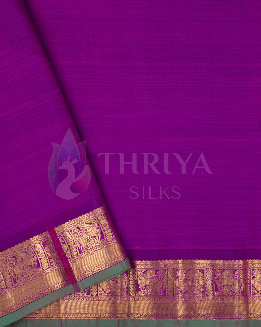 Plain purple blouse piece with matching gold zari border and green selvedge
