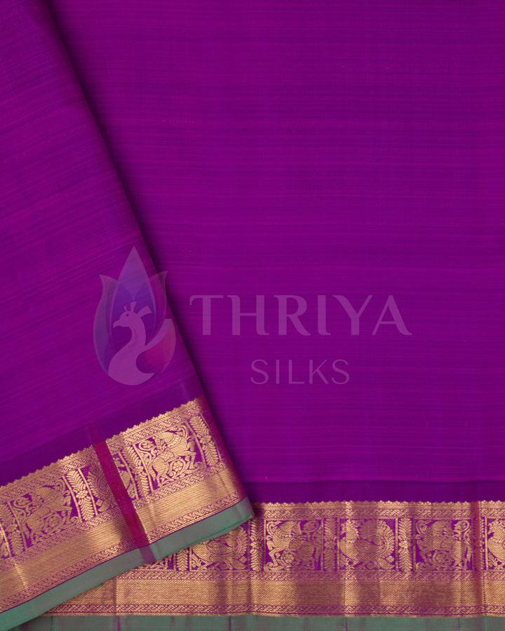Plain purple blouse piece with matching gold zari border and green selvedge
