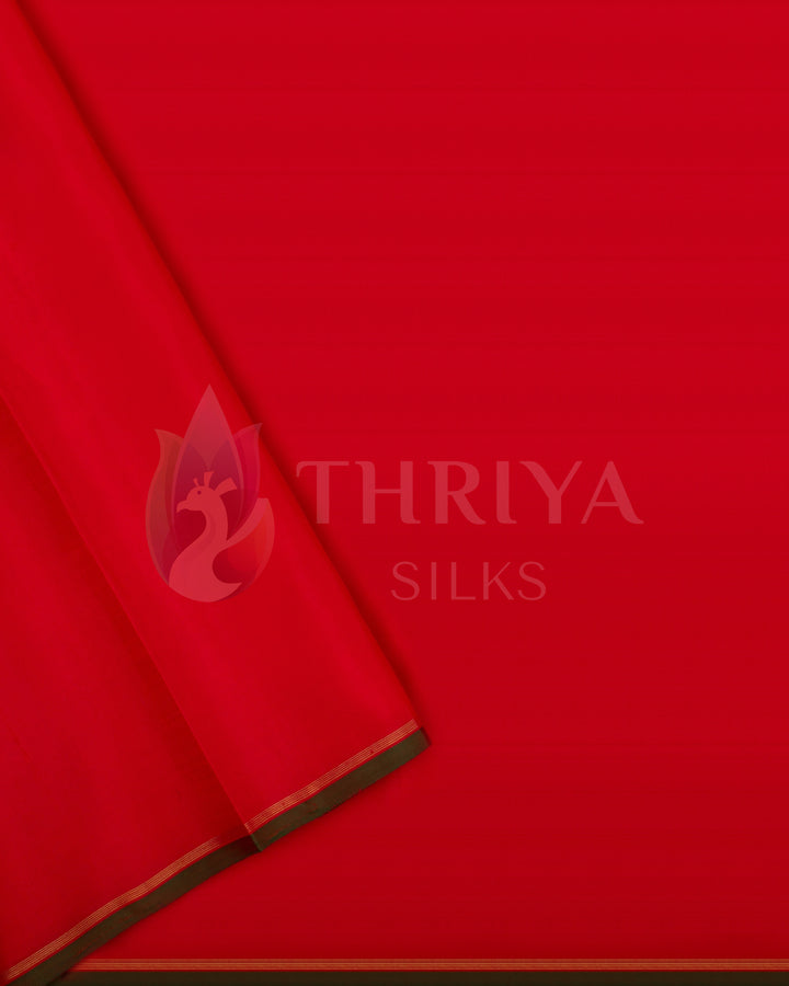 Matching red blouse piece with delicate zari edge and green piping – Kanjivaram silk saree from Thriya Silks