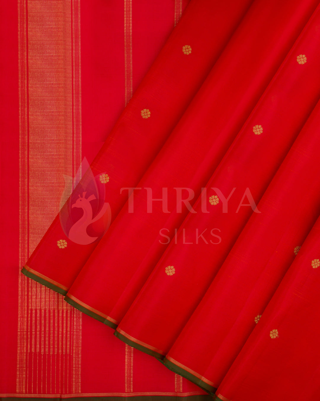 Vibrant red Kanjivaram silk saree with gold zari buttas and striped pallu – front pleated view from Thriya Silks