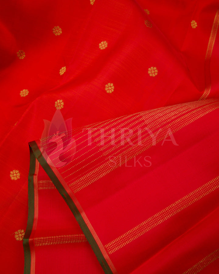 Close-up of soft red Kanjivaram silk saree with golden woven motifs and zari pallu – Thriya Silks