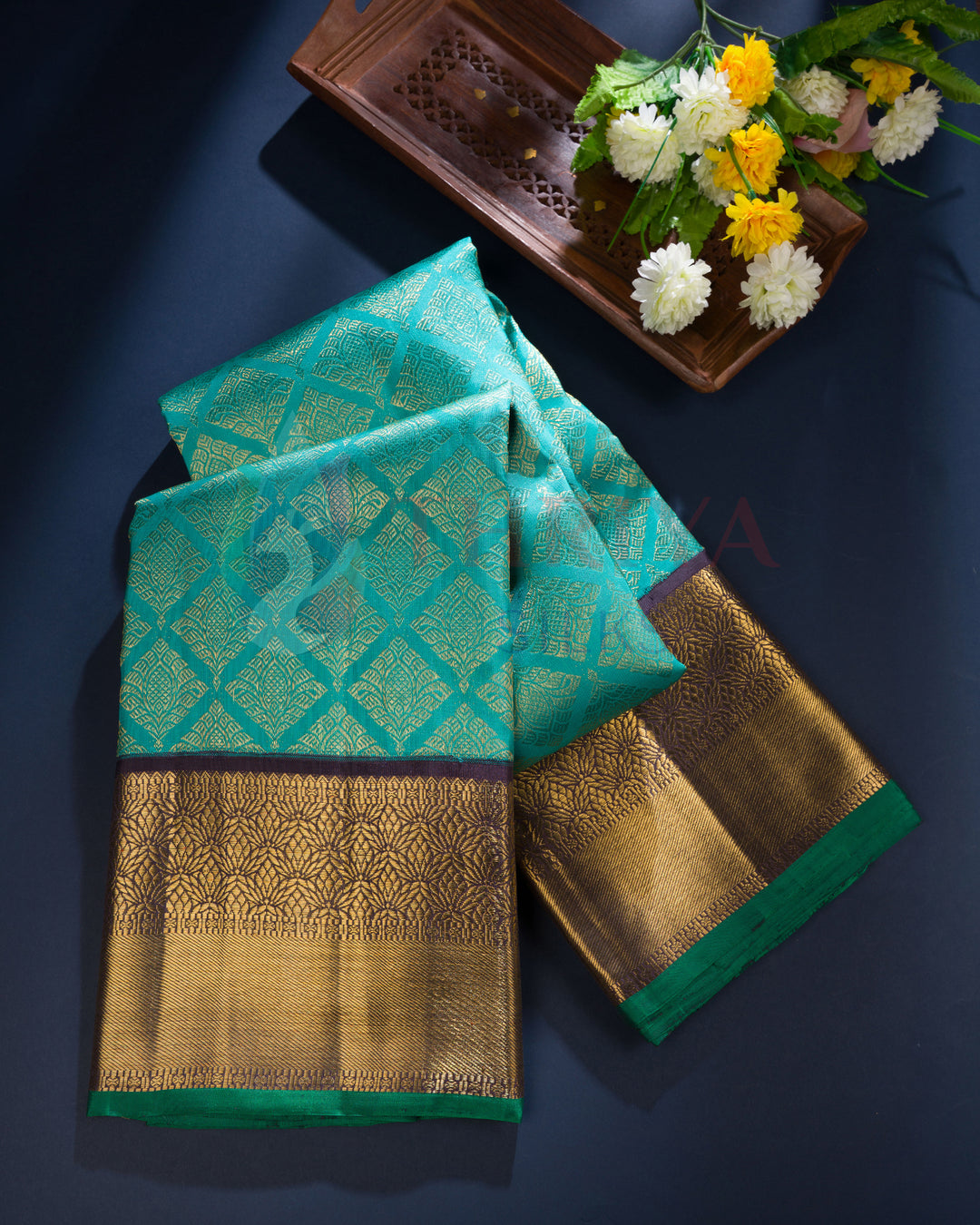 Teal Kanchipuram silk saree with gold zari border and diamond motifs