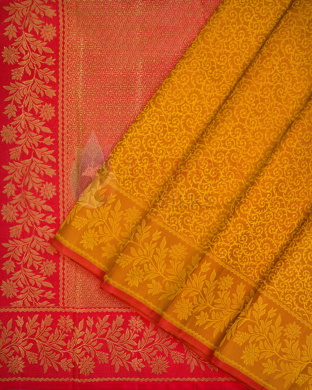Yellow-orange Kanjivaram silk saree with intricate floral golden zari weave and contrasting red border