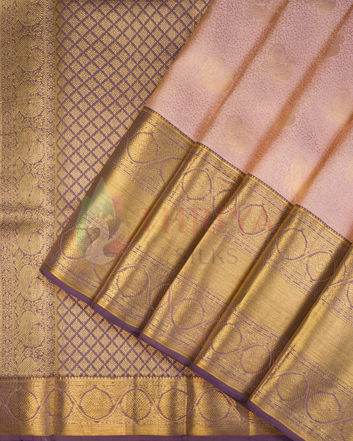 Light pink Kanjivaram silk saree with golden zari butta and contrast purple border