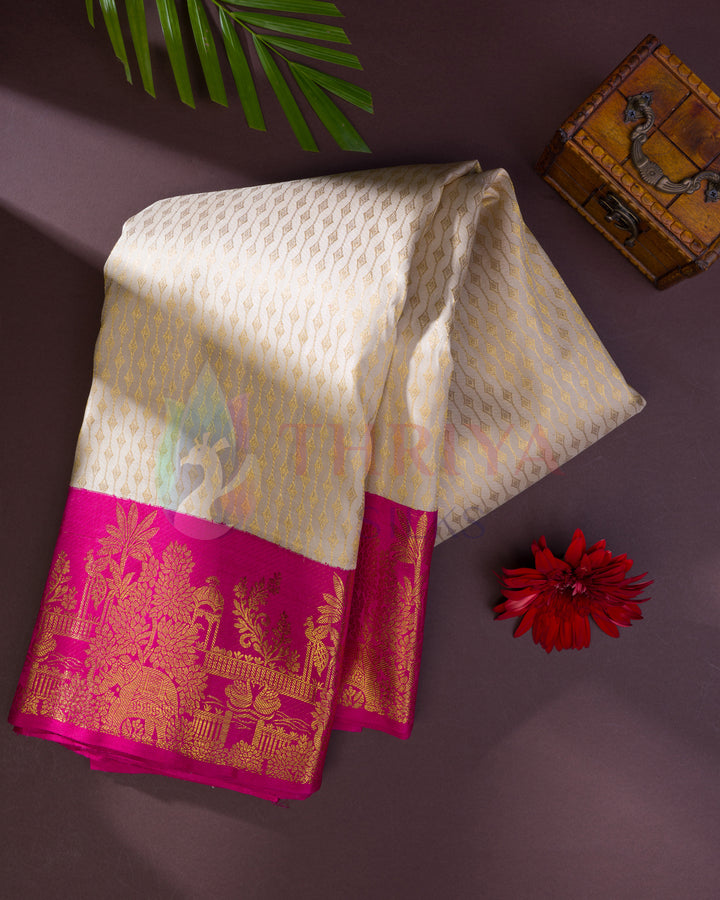 Folded off-white Kanjivaram silk saree showcasing vibrant pink and gold zari temple border and floral patterns