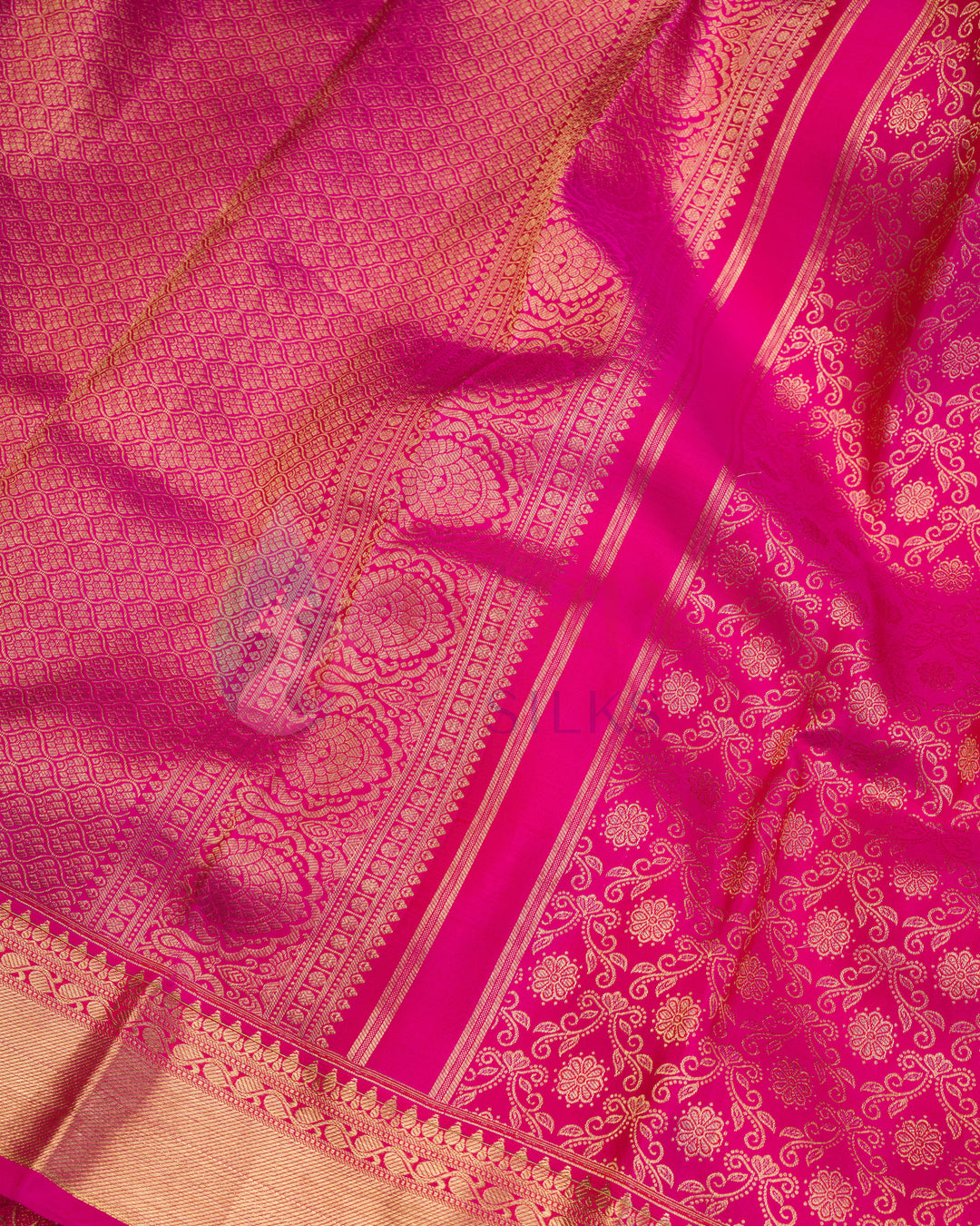 Close-up of floral zari pattern on rich pink silk saree with detailed pallu