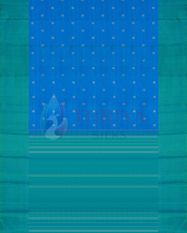 Full view of blue silk saree with green border and golden zari polka dot motifs