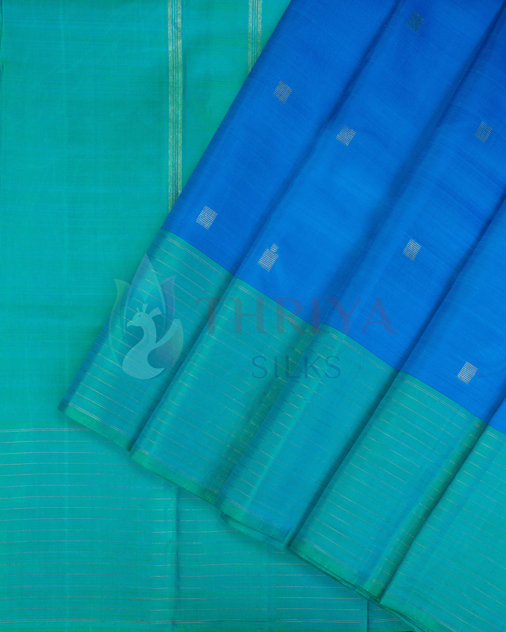 Blue silk saree with green border featuring golden zari stripes and delicate motifs
