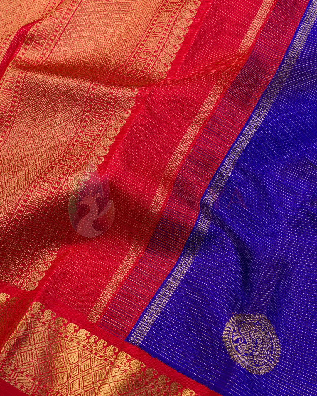 Royal blue Kanjivaram silk saree with gold zari buti motifs and rich red zari floral pallu and border