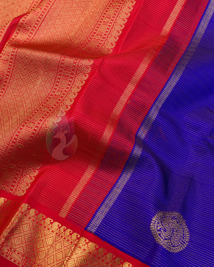 Royal blue Kanjivaram silk saree with gold zari buti motifs and rich red zari floral pallu and border