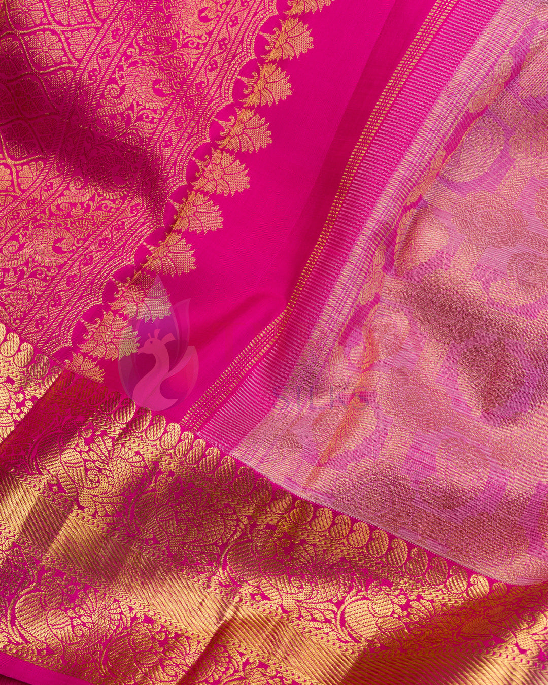 Close-up of golden zari pallu with traditional floral and paisley motifs on pink Kanjivaram saree