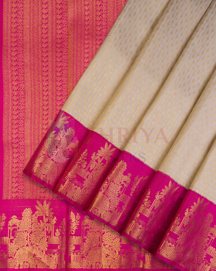 Off-white Kanjivaram silk saree with intricate golden zari floral motifs and vibrant pink border with temple designs