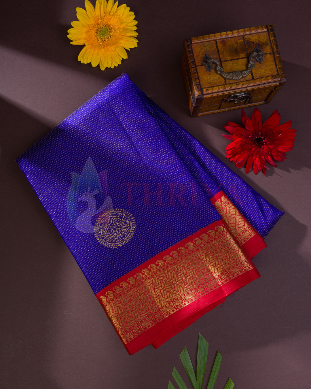 Full royal blue Kanjivaram silk saree with gold zari butis and red zari floral border
