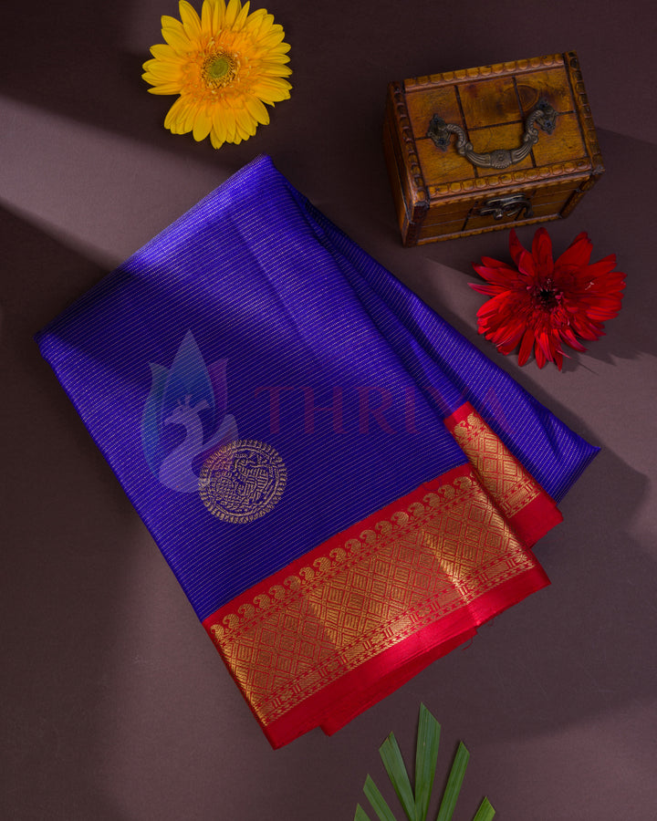 Full royal blue Kanjivaram silk saree with gold zari butis and red zari floral border