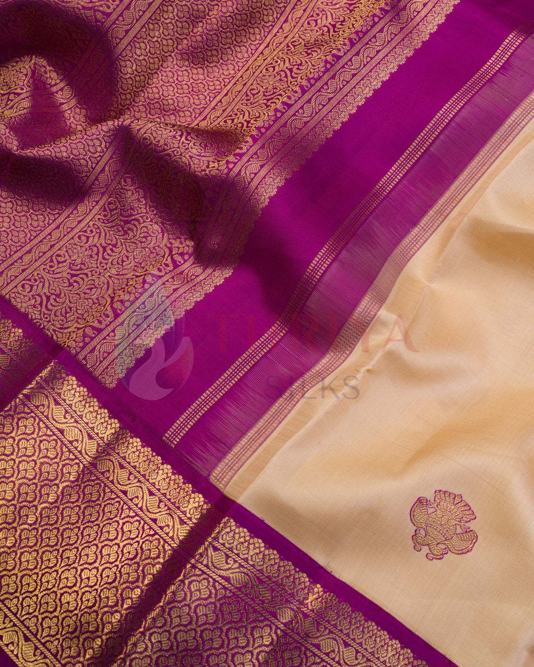 Detailed view of purple and cream Kanjivaram silk saree pallu with intricate golden zari floral patterns