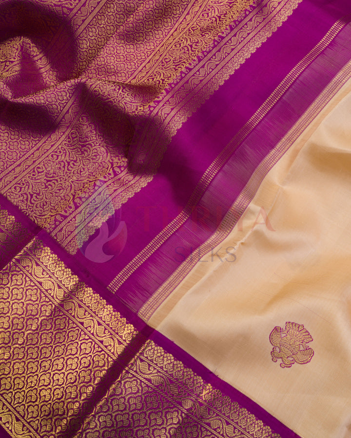 Detailed view of purple and cream Kanjivaram silk saree pallu with intricate golden zari floral patterns