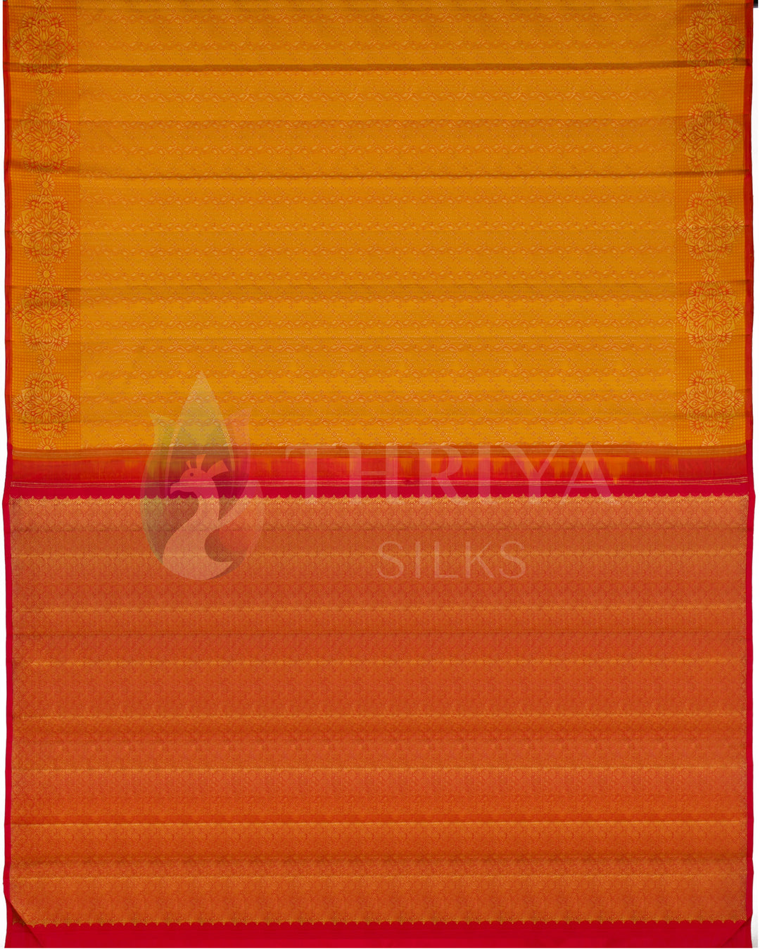 Flatlay of Banarasi silk saree showing contrast red pallu and golden yellow body with zari weave