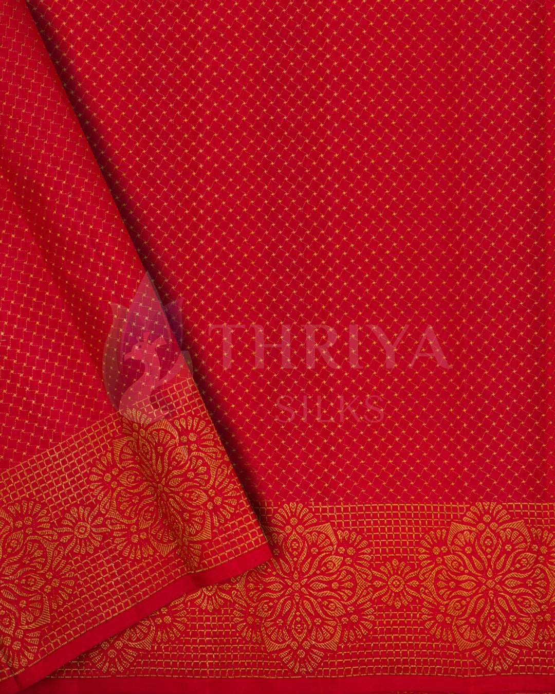 Close-up of red section from Banarasi silk saree featuring gold diamond buttas and floral zari border