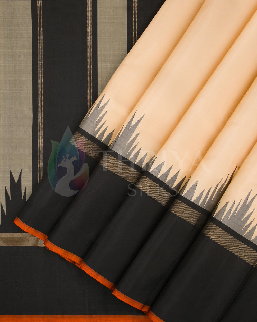 Pleats view of beige and black silk saree featuring temple border design with orange piping