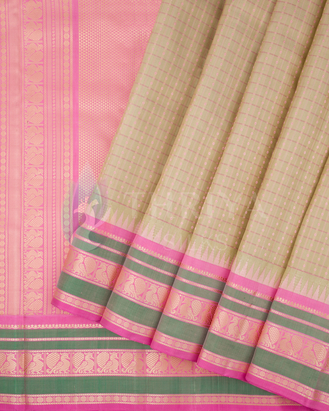 Close-up of beige and pink Kanjivaram silk saree pallu with intricate gold zari and green border design