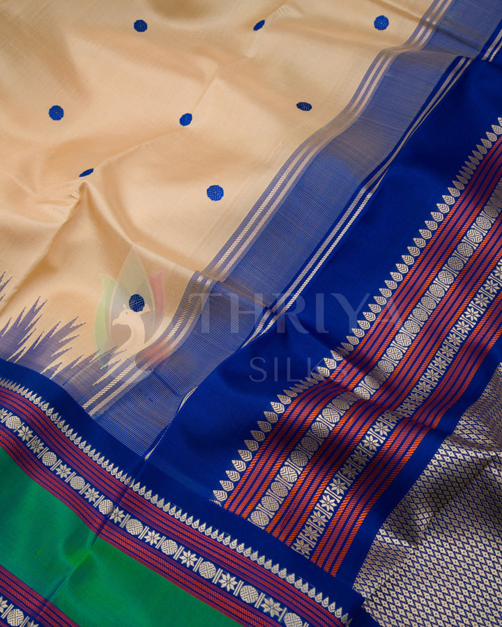 Close-up of beige saree body with blue and red zari pallu and contrast green border, Thriya Silks