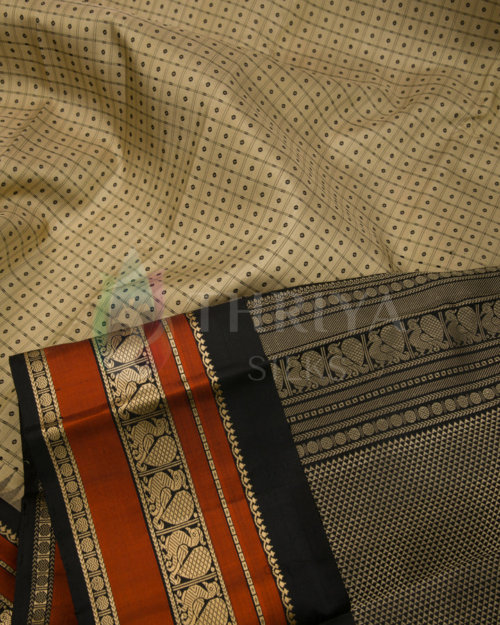 Detailed view of beige silk saree body with rust-orange border and rich black pallu, Thriya Silks
