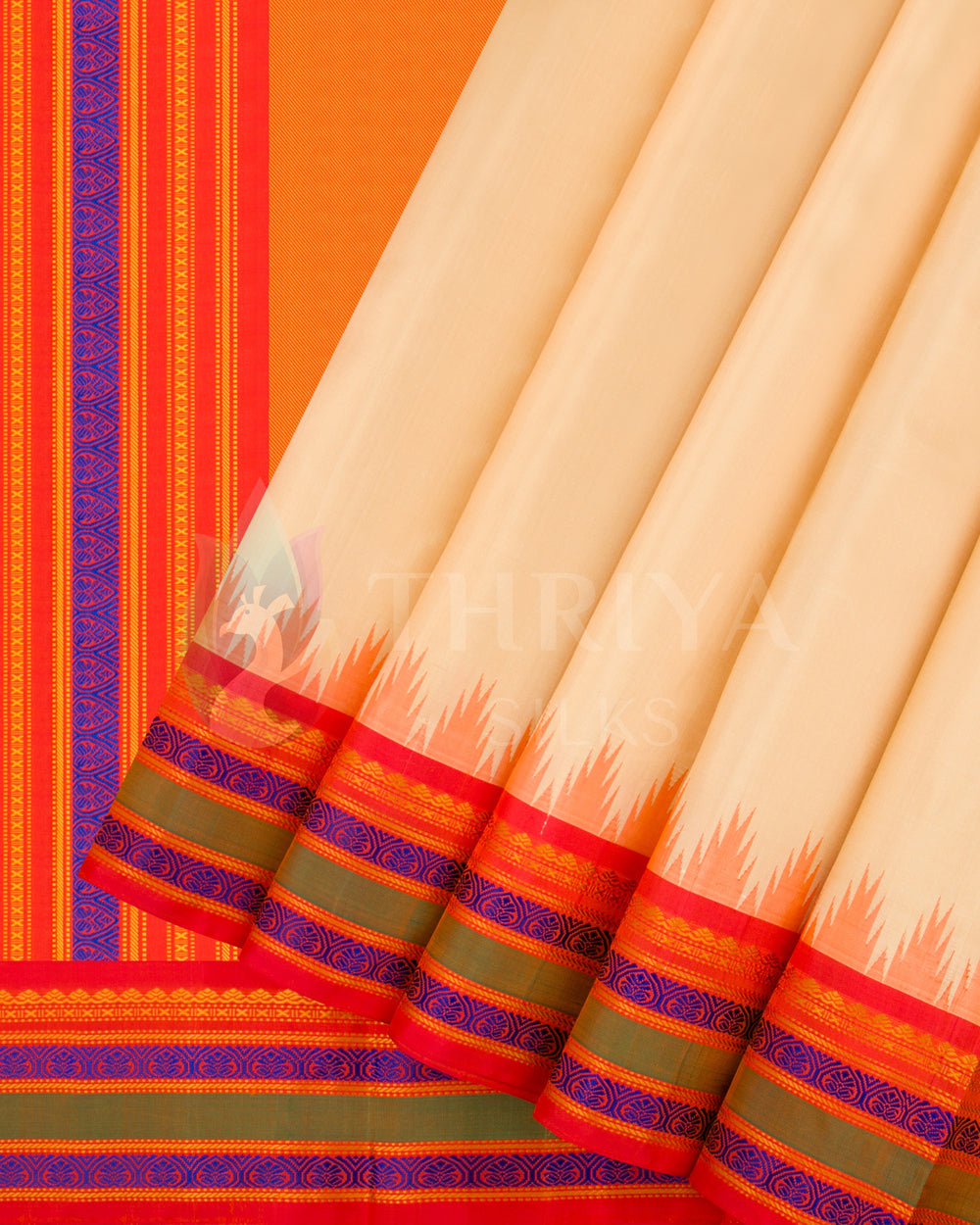 Beige silk saree with red-orange pleats and blue zari border, from Thriya Silks