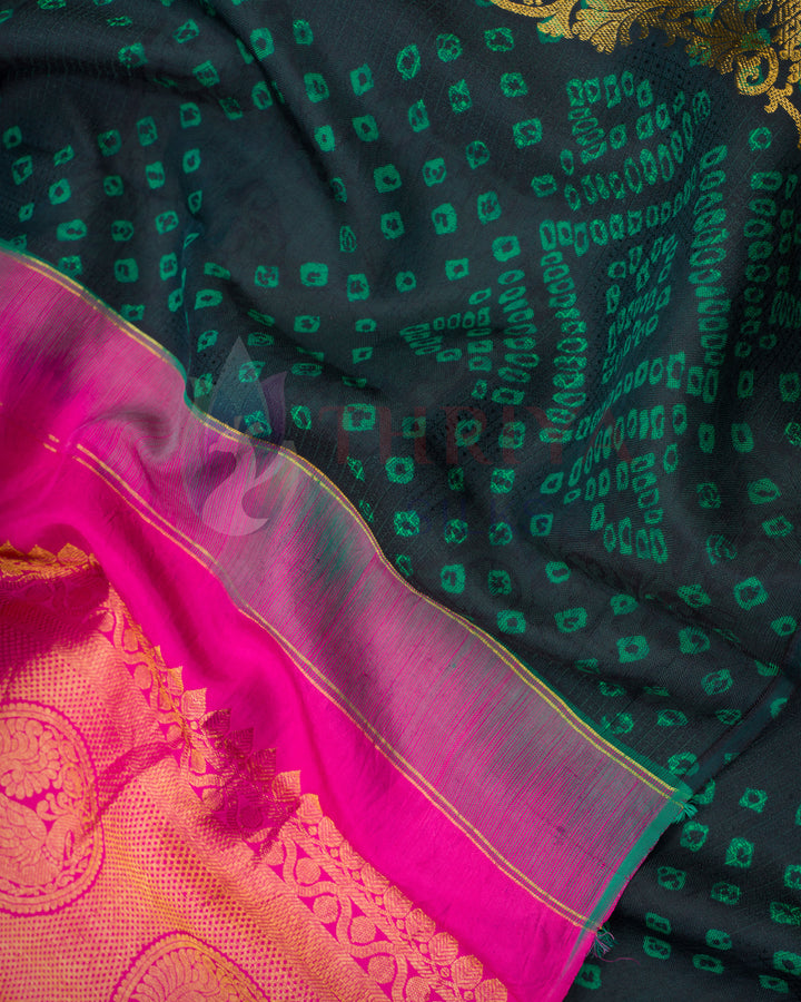 Close-up of black green silk saree with pink and golden zari border – Kanchipuram saree