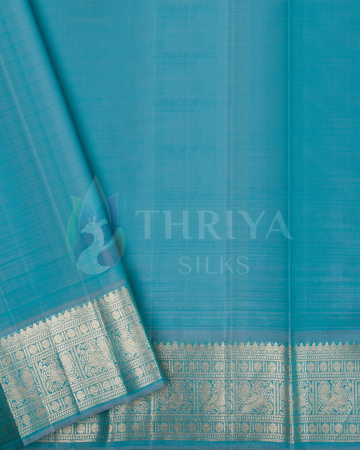 Turquoise blue blouse piece with rich silver zari border from the pastel green silk saree