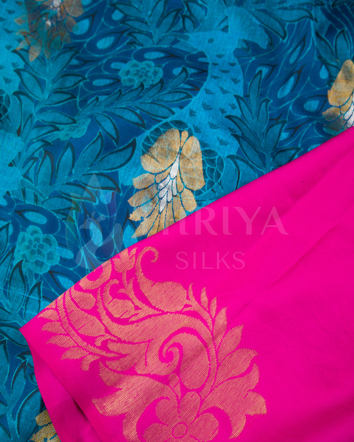 Close-up of blue floral Banarasi weave paired with pink pallu featuring intricate golden motifs.