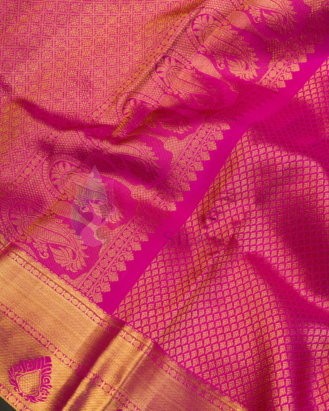Close-up of zari border with paisley designs on pink Kanchipuram silk saree