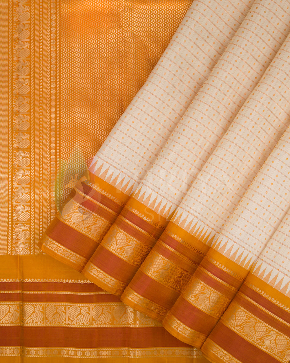Pleated drape view of cream and orange silk saree showcasing gold zari border and pallu