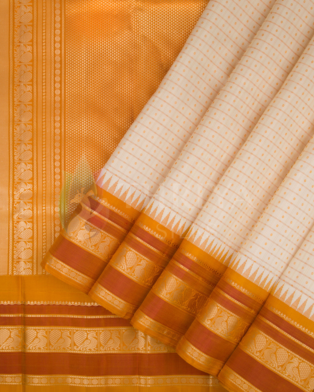 Pleated drape view of cream and orange silk saree showcasing gold zari border and pallu