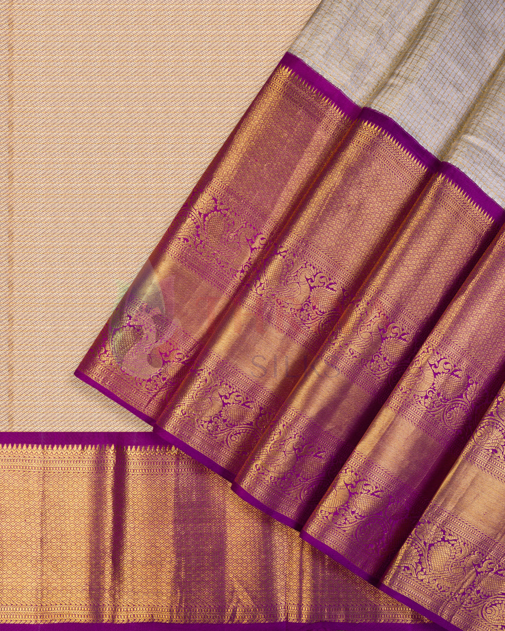 Cream Kanjivaram silk saree with golden body weave and rich purple zari pallu and border