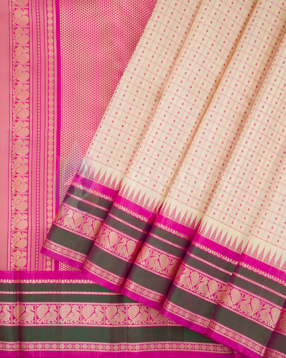 Elegant cream silk saree with pink zari border and olive green detailing from Thriya Silks