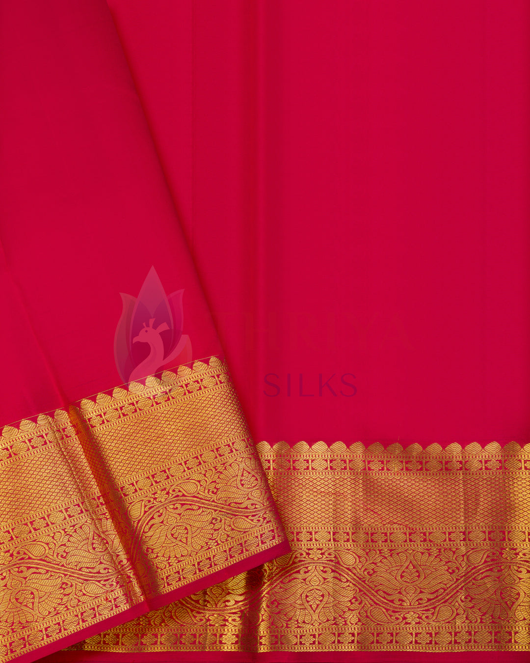 Rust Kanjivaram silk saree draped elegantly with gold zari border and pink blouse