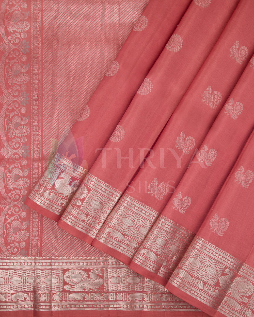 Dusty rose pink Kanjivaram silk saree with silver zari border and traditional motifs
